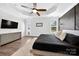 Comfortable main bedroom featuring a TV, dresser, and large window with natural light at 3981 Spinnaker Pl, Denver, NC 28037