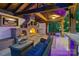 Luxury outdoor kitchen with a stone fireplace, TV, comfortable seating, and a well-designed entertainment area at 3981 Spinnaker Pl, Denver, NC 28037