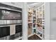 A well-organized pantry with built-in shelving, providing ample storage space for food items at 3981 Spinnaker Pl, Denver, NC 28037