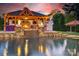 Gorgeous pool with an outdoor kitchen featuring a built-in stone fireplace and stylish bar seating at 3981 Spinnaker Pl, Denver, NC 28037