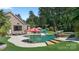 Backyard features a luxurious pool with a tanning ledge, lounge chairs, and mature landscaping at 3981 Spinnaker Pl, Denver, NC 28037