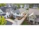 Aerial view of the backyard with a patio, basketball hoop, gated driveway, and well-maintained landscaping, showcasing privacy and space at 508 Mcalway Rd, Charlotte, NC 28211
