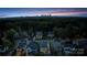 A twilight aerial view of a residential neighborhood with the city skyline in the distance at 508 Mcalway Rd, Charlotte, NC 28211