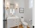Well-lit powder room with a classic vanity, decorative mirror, and elegant fixtures at 508 Mcalway Rd, Charlotte, NC 28211