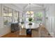 Bright dining room with an oval table, chandelier, and multiple windows at 508 Mcalway Rd, Charlotte, NC 28211