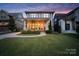Inviting two-story home featuring a spacious front porch, manicured lawn, and a blend of traditional and modern design elements at 508 Mcalway Rd, Charlotte, NC 28211