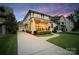 Beautiful two-story home with a charming front porch, lush landscaping, and a long driveway leading to a detached garage at 508 Mcalway Rd, Charlotte, NC 28211