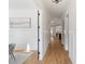Bright hallway featuring hardwood floors, white trim, and decorative wall paneling at 508 Mcalway Rd, Charlotte, NC 28211