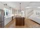 Modern kitchen features a large center island, stainless steel appliances, and white cabinets at 508 Mcalway Rd, Charlotte, NC 28211