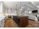 A spacious kitchen and connecting living room with a center island that includes a wine cooler at 508 Mcalway Rd, Charlotte, NC 28211