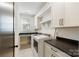 Well-lit laundry room with modern washer, dryer, counter space and storage at 508 Mcalway Rd, Charlotte, NC 28211