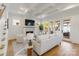 Bright living room with a fireplace, white sofa, and large windows with access to an outdoor seating area at 508 Mcalway Rd, Charlotte, NC 28211