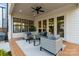 Covered patio with neutral outdoor seating, ceiling fan, and glass doors at 508 Mcalway Rd, Charlotte, NC 28211