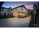 The back of the house features a patio with seating, a basketball hoop, and a driveway with a gated entrance at 508 Mcalway Rd, Charlotte, NC 28211