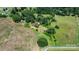 Aerial view showcases the property's acreage, surrounding trees, and the home's proximity to nature at 5560 Springs Rd, Conover, NC 28613
