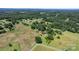 Aerial view of the farm and home from above the acreage and trees with road access nearby at 5560 Springs Rd, Conover, NC 28613