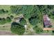 Aerial view of the property highlighting the home, outbuildings, and surrounding landscape at 5560 Springs Rd, Conover, NC 28613