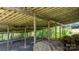 Interior of open-air barn, showcasing the structure's post and beam construction with a backdrop of lush greenery at 5560 Springs Rd, Conover, NC 28613
