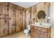 A functional bathroom with toilet, sink, vanity, and wood paneled walls at 5560 Springs Rd, Conover, NC 28613