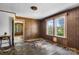 Cozy bedroom features wood paneled walls and two windows offering natural light at 5560 Springs Rd, Conover, NC 28613