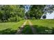 Picturesque driveway winding through lush greenery, leading to a charming home nestled in a serene, tree-filled setting at 5560 Springs Rd, Conover, NC 28613