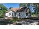 Charming home showcasing a sunroom, classic architecture, and a peaceful outdoor seating area surrounded by greenery at 5560 Springs Rd, Conover, NC 28613