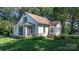 Classic home featuring a sunroom, well-kept lawn, and lovely flowerbeds, enhancing its welcoming outdoor space at 5560 Springs Rd, Conover, NC 28613