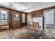Living room features wood paneled walls, fireplace, doorway and exterior door at 5560 Springs Rd, Conover, NC 28613