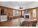 Spacious living room with wood paneled walls, fireplace, and plenty of natural light at 5560 Springs Rd, Conover, NC 28613