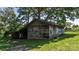 Rustic outbuilding with weathered wood and a for sale sign, set in a grassy yard at 5560 Springs Rd, Conover, NC 28613