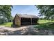 Rustic outbuilding with a weathered wood exterior, offering potential storage or workshop space at 5560 Springs Rd, Conover, NC 28613