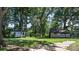 Picturesque backyard with two rustic outbuildings surrounded by mature trees and greenery at 5560 Springs Rd, Conover, NC 28613