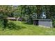 Scenic view of the house and outbuildings surrounded by lush greenery, showcasing the property's charm at 5560 Springs Rd, Conover, NC 28613