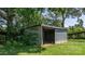 Open storage shed nestled among mature trees, perfect for outdoor equipment or workshop at 5560 Springs Rd, Conover, NC 28613