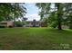 Spacious backyard with mature trees, offering privacy and a serene view of the property and neighborhood at 5727 Faulconbridge Rd, Charlotte, NC 28227