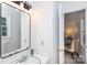 Clean white bathroom features a sink, mirror and doorway leading to another room at 5727 Faulconbridge Rd, Charlotte, NC 28227