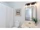 Updated bathroom with shower/tub combination, patterned mirror, and bright vanity lighting at 5727 Faulconbridge Rd, Charlotte, NC 28227