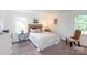 Cozy bedroom with neutral tones, carpet, and bright windows fills the room with natural light at 5727 Faulconbridge Rd, Charlotte, NC 28227