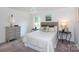 Cozy bedroom with neutral tones, carpet, and bright windows fills the room with natural light at 5727 Faulconbridge Rd, Charlotte, NC 28227