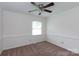 Empty bedroom with carpet, window, ceiling fan, and white walls shows the room's layout at 5727 Faulconbridge Rd, Charlotte, NC 28227