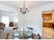 Cozy dining room featuring natural light, classic chandelier, with an adjoining living space at 5727 Faulconbridge Rd, Charlotte, NC 28227