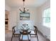 Inviting dining room with contemporary light fixture, modern art, and bright window views at 5727 Faulconbridge Rd, Charlotte, NC 28227