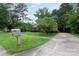 Inviting home with well-maintained lawn and driveway, showcasing its curb appeal and charming neighborhood setting at 5727 Faulconbridge Rd, Charlotte, NC 28227