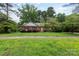 Charming brick home with a well-manicured front lawn, showcasing a classic and inviting curb appeal at 5727 Faulconbridge Rd, Charlotte, NC 28227