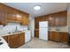 Bright kitchen with plenty of oak cabinets, tile floors, and modern appliances at 5727 Faulconbridge Rd, Charlotte, NC 28227
