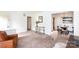 Comfortable living room featuring neutral colored carpet, traditional decor, and lots of natural light at 5727 Faulconbridge Rd, Charlotte, NC 28227