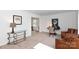 Cozy living room with light colored carpet, study nook, and comfortable leather furniture at 5727 Faulconbridge Rd, Charlotte, NC 28227