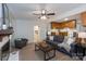 Inviting living room featuring a comfortable gray sofa, fireplace, and easy access to the kitchen and laundry at 5727 Faulconbridge Rd, Charlotte, NC 28227