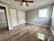 Spacious bedroom with wood floors, a ceiling fan, and a closet for ample storage space at 60 White Oaks Dr, Taylorsville, NC 28681