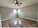 Bright bedroom featuring wood floors, neutral paint, and natural light from two windows at 60 White Oaks Dr, Taylorsville, NC 28681
